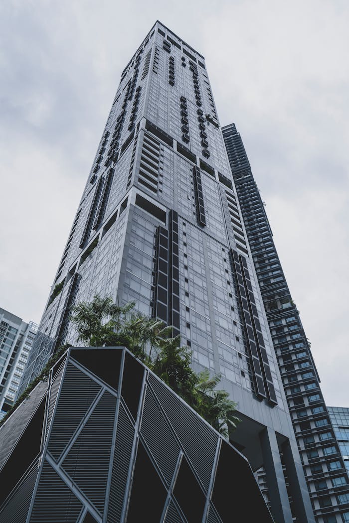 Impressive low angle view of a modern skyscraper showcasing sleek city architecture.