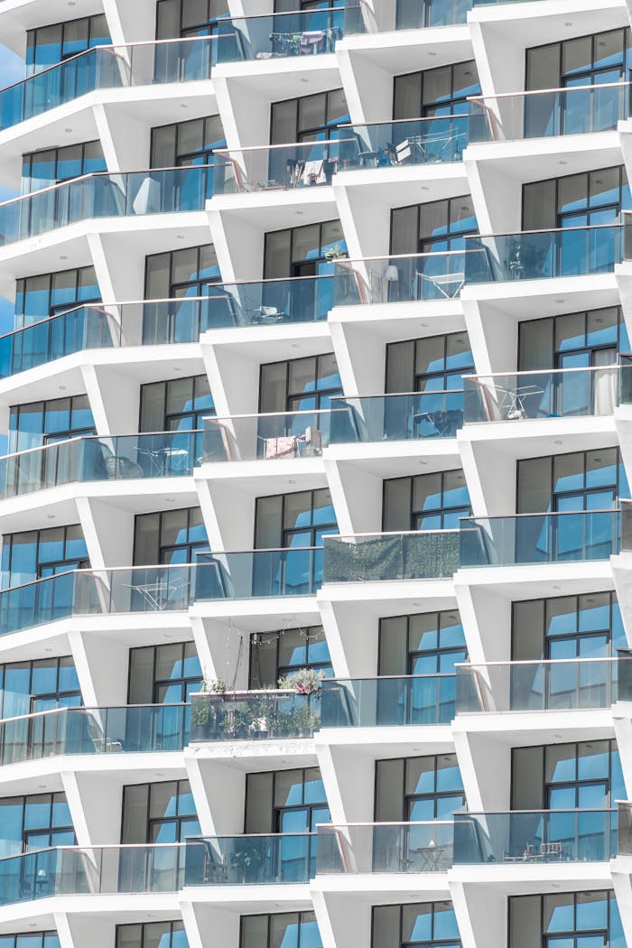 Contemporary apartment building facade in Dubai with striking geometric patterns and glass balconies.