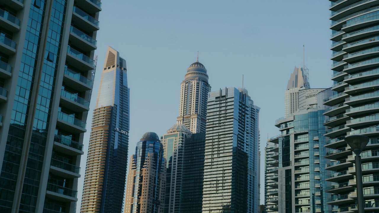 A view of modern high-rise skyscrapers under a clear sky, capturing an urban landscape.